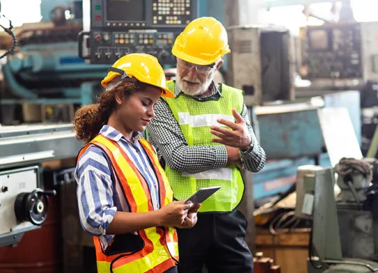 a man and a woman on manufacturing plant floor
